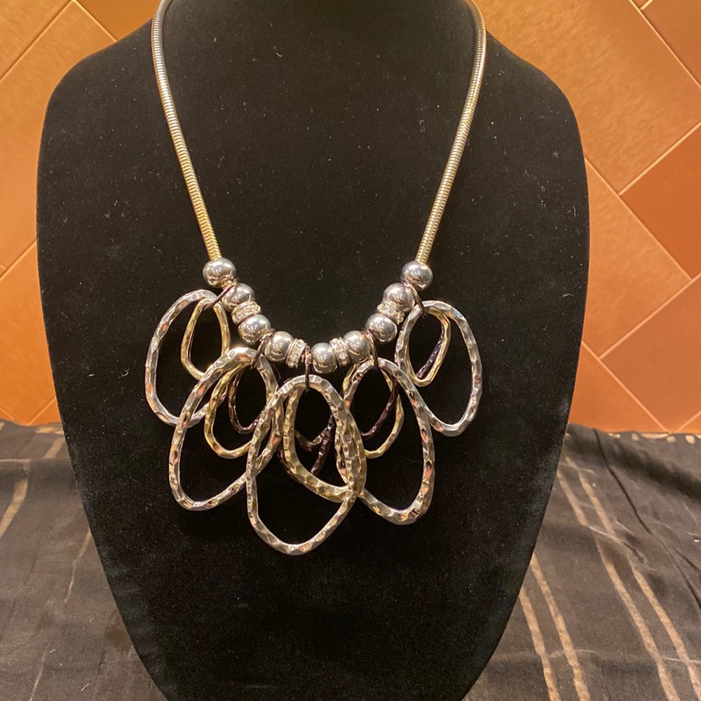 Chico’s gold necklace with silver, gold, and bronze hoops